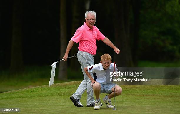 Bruce Whipham of Kirby Muxloe Golf Club and Joseph Halfpenny of Kirby Muxloe Golf Club line up a putt on the 16th green during the PGA National...