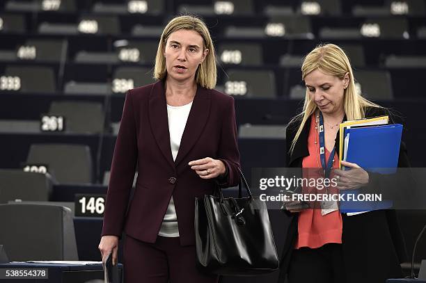 European Union foreign policy chief Federica Mogherini speaks with her assistant prior to a debate on a new EU plan to address the root causes of...
