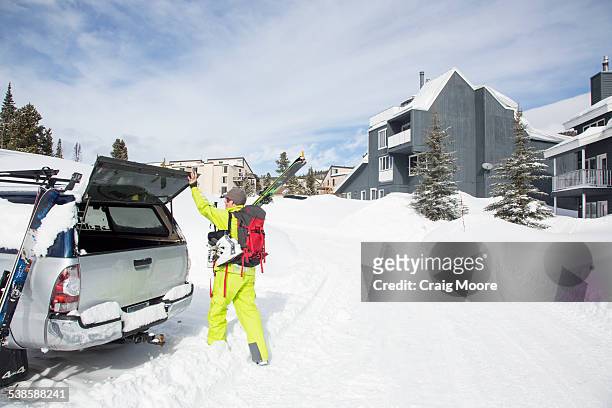 a fit female skier loads her ski gear in a truck at big sky resort in big sky, montana. - big sky ski resort stock pictures, royalty-free photos & images