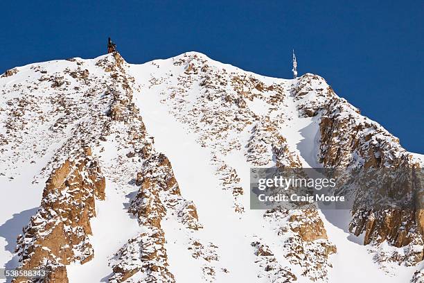 two skiers hike to their ski line in the a-z chutes at big sky resort in big sky, montana. - big sky ski resort stock pictures, royalty-free photos & images