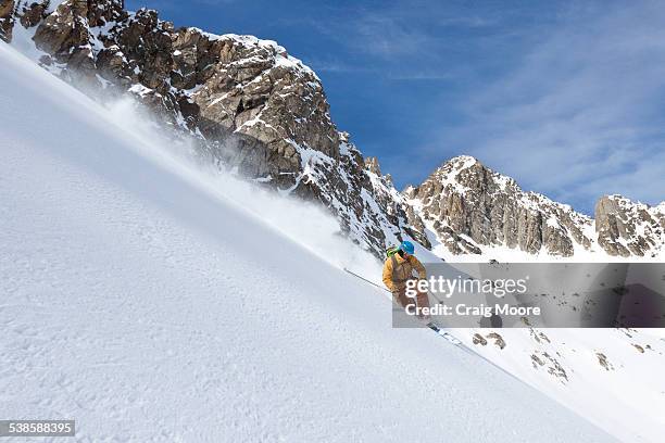 a male backcountry skier makes a powder turn in the beehive basin near big sky, montana. - basin montana bildbanksfoton och bilder