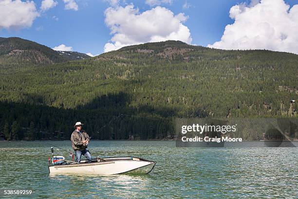 a man fishing on whitefish lake in whitefish, montana. - whitefish lake stockfoto's en -beelden