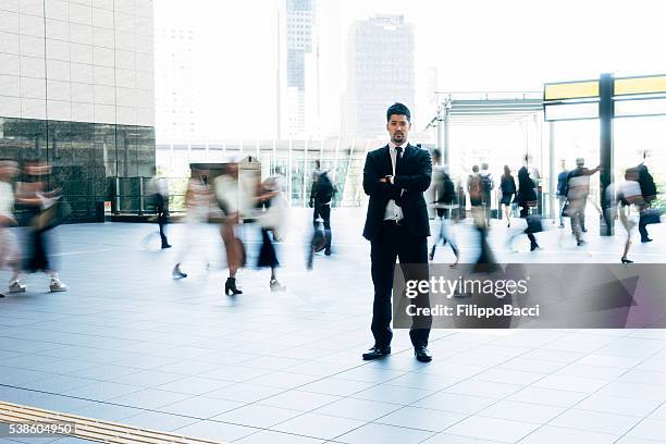 businessman motionless in the crowd - bussines group suit tie stock pictures, royalty-free photos & images