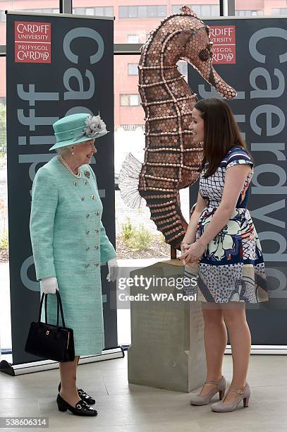 Queen Elizabeth II chats with PhD student Gemma Williams from Cardiff University's School of Psychology at the Cardiff University Brain Research...