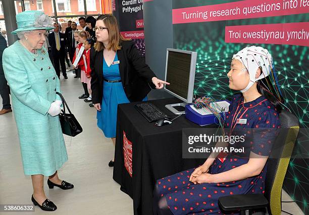 Queen Elizabeth II meets Dr Grace Xia at the opening of the Cardiff University Brain Research Imaging Centre on June 7, 2016 in Cardiff, Wales.