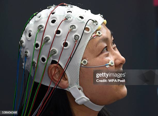 Dr Grace Xia, speaks to CARDIFF, WALES A woman takes part in a demonstration at the opening of the Cardiff University Brain Research Imaging Centre,...