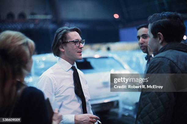 American artist Robert Whitman talks with unidentified others during the set-up for his 'Two Holes of Water - 3' piece, a part of '9 Evenings:...