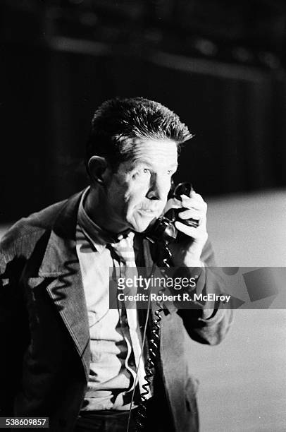 Close-up of American composer John Cage as he uses a telephone as part of his 'Variations VII' piece during '9 Evenings: Theatre & Engineering' at...