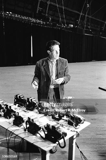 View of American composer John Cage as he sets up telephones for part of his 'Variations VII' piece during '9 Evenings: Theatre & Engineering' at the...