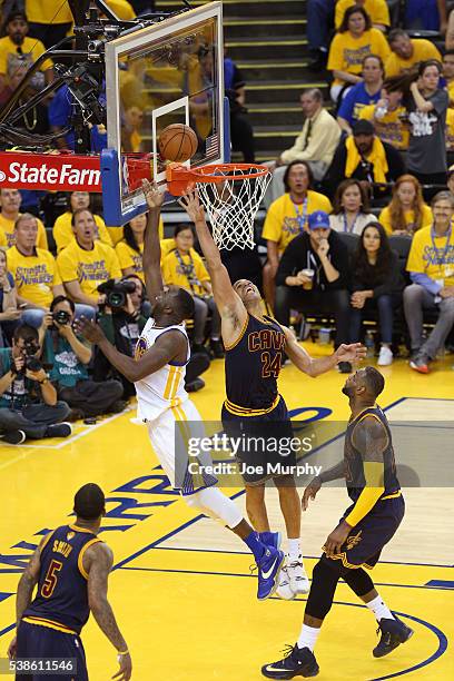 Draymond Green of the Golden State Warriors drives to the basket and shoots the ball while guarded by Richard Jefferson of the Cleveland Cavaliers...