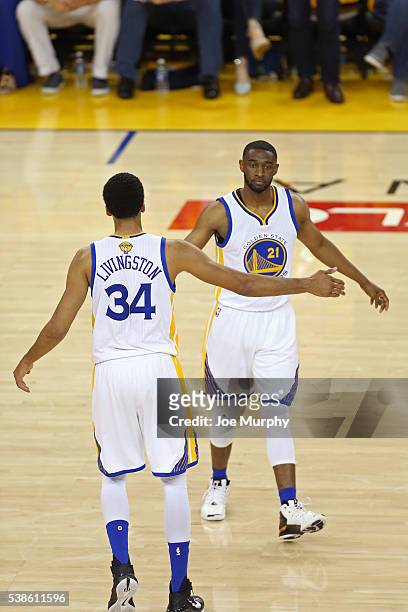 Shaun Livingston and Ian Clark of the Golden State Warriors high five during Game Two of the 2016 NBA Finals against the Cleveland Cavaliers on June...