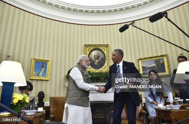 President Barack Obama shakes hands with India's Prime Minister Narendra Modi during a meeting in the Oval Office of the White House on June 7, 2016...