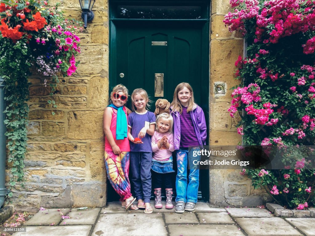 Happy children standing together in doorway