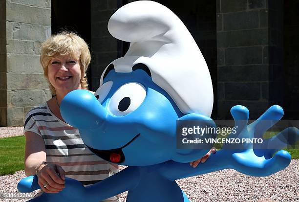 Veronique Culliford, daughter of Smurfs creator the Belgian cartoonist Pierre Culliford, who worked under the pseudonym of Peyo, poses next to a...