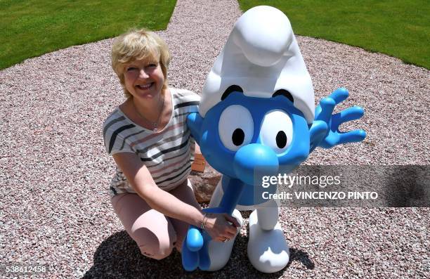 Veronique Culliford, daughter of Smurfs creator the Belgian cartoonist Pierre Culliford, who worked under the pseudonym of Peyo, poses next to a...