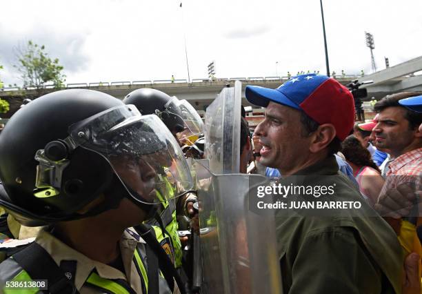 Miranda state Governor Henrique Capriles argues with police as he leads an opposition march attempting to reach the National Electoral Court in...