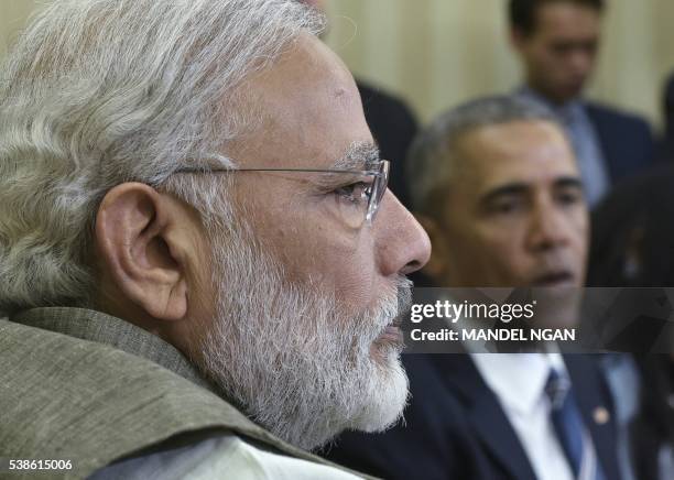 India's Prime Minister Narendra Modi watches as US President Barack Obama speaks during a bilateral meeting in the Oval Office of the White House on...