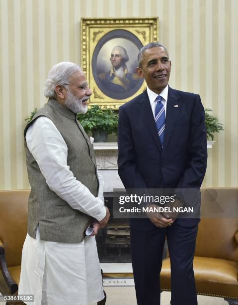 India's Prime Minister Narendra Modi waves as US President Barack Obama looks on following a meeting in the Oval Office of the White House on June 7,...