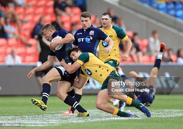 Jack Maddocks of Australia tackles Tom Galbraith of Scotland during the World Rugby U20 Championship match at the AJ Bell Stadium on June 7, 2016 in...