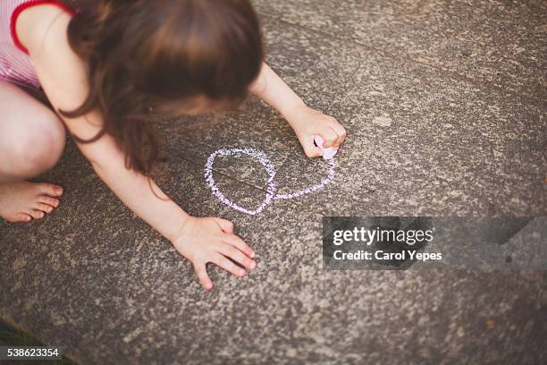 girl drawing with sidewalk chalk - human tongue drawing stock pictures, royalty-free photos & images