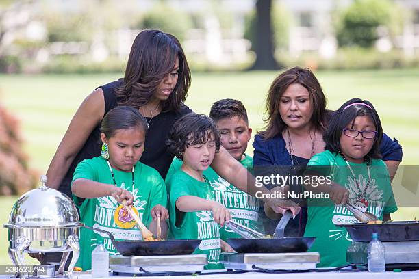Washington, DC On Monday, June 6, on the South Lawn of the White House, l-r, First Lady Michelle Obama, and Rachel Ray, help kids prepare lunch made...
