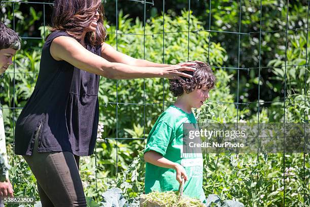 Washington, DC On Monday, June 6, on the South Lawn of the White House, First Lady Michelle Obama, with one of the kids who helped harvest vegetables...