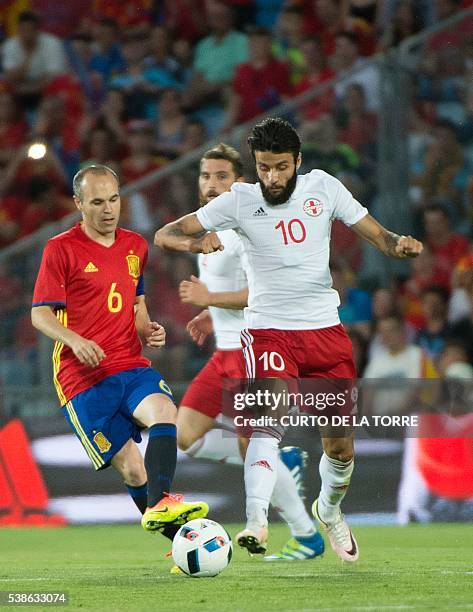 Spain's midfielder Andres Iniesta vies with Georgia's midfielder Tornike Okriashvili during the EURO 2016 friendly football match Spain vs Georgia at...