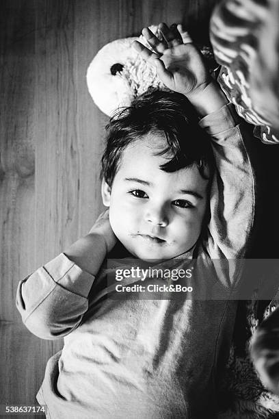 boy lying on his back looking at camera - descansando stock pictures, royalty-free photos & images