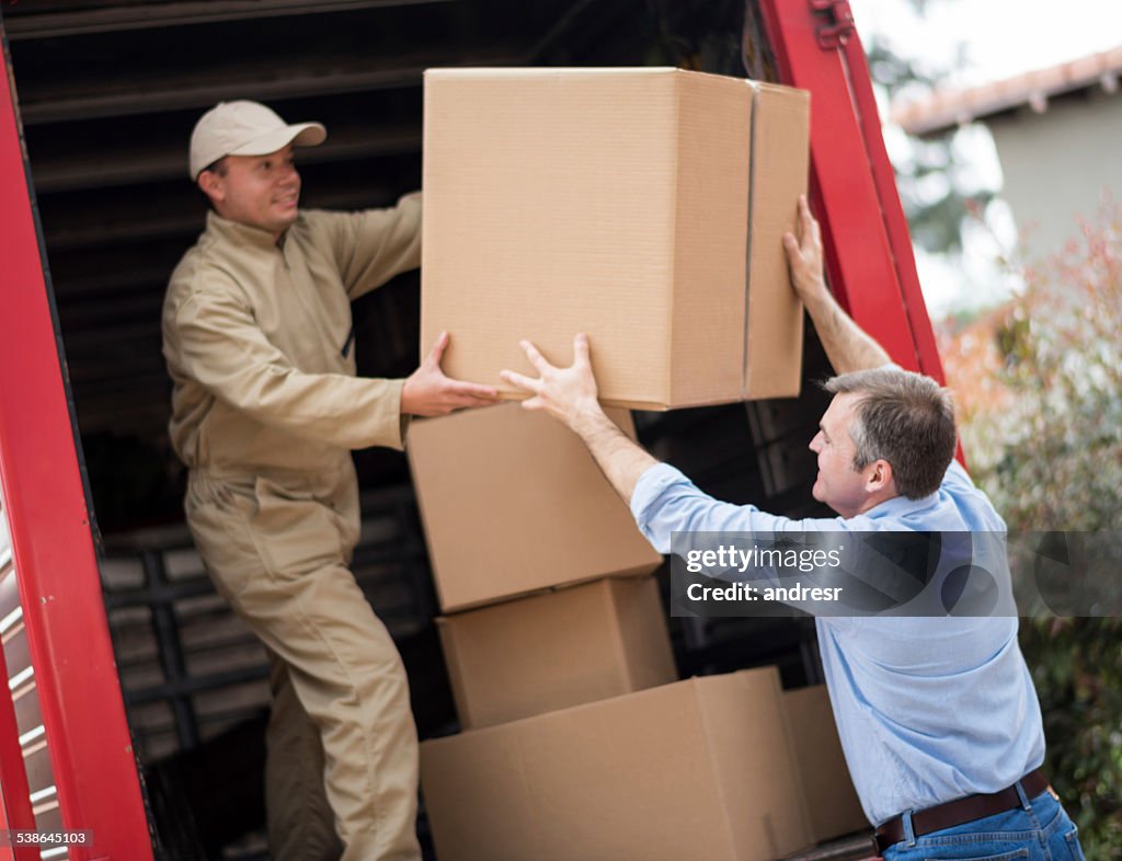 Man loading a moving truck with movers