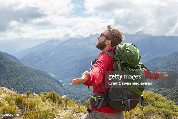 man finds freedom and success in nature - milford track stock pictures, royalty-free photos & images