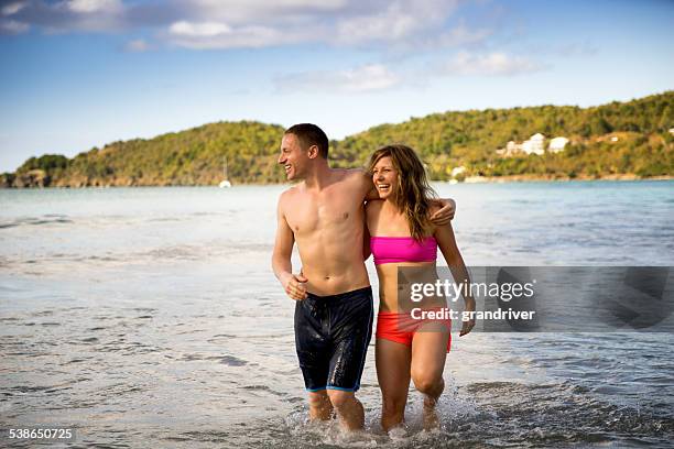 young couple playing in water - wade bildbanksfoton och bilder