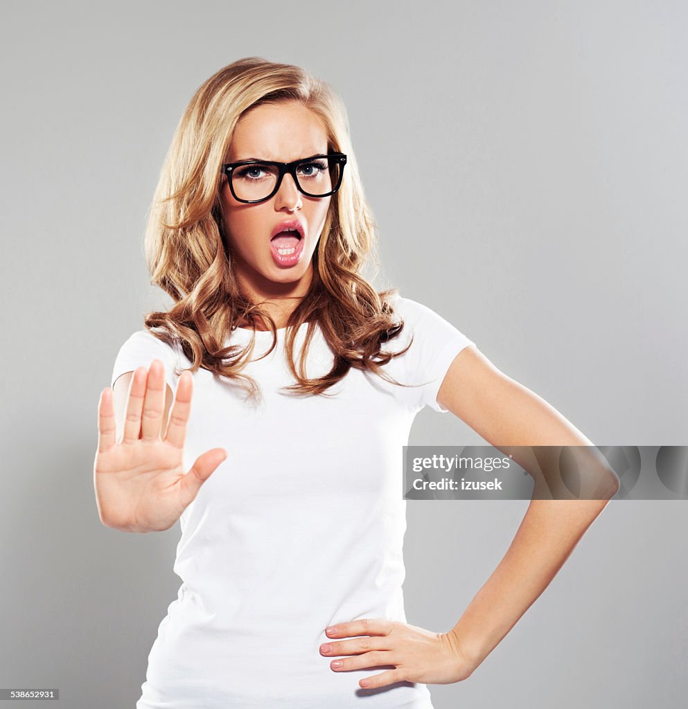 Young woman in refusal gesture, Studio Portrait