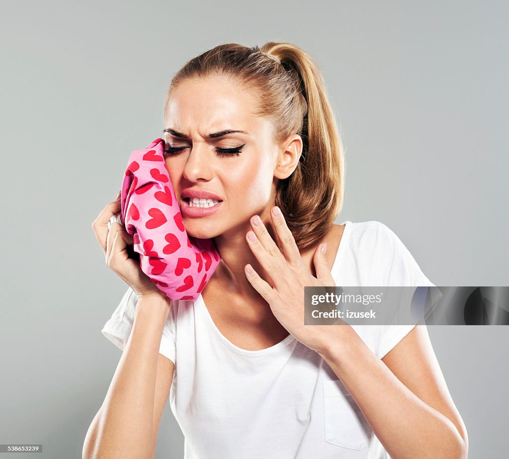 Young woman suffering from toothache