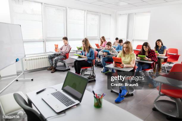 high school students using digital tablets in modern classroom. - modern classroom stock pictures, royalty-free photos & images