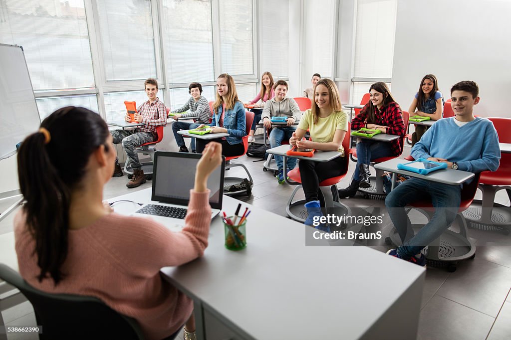 Large group of high school students attending a modern class.