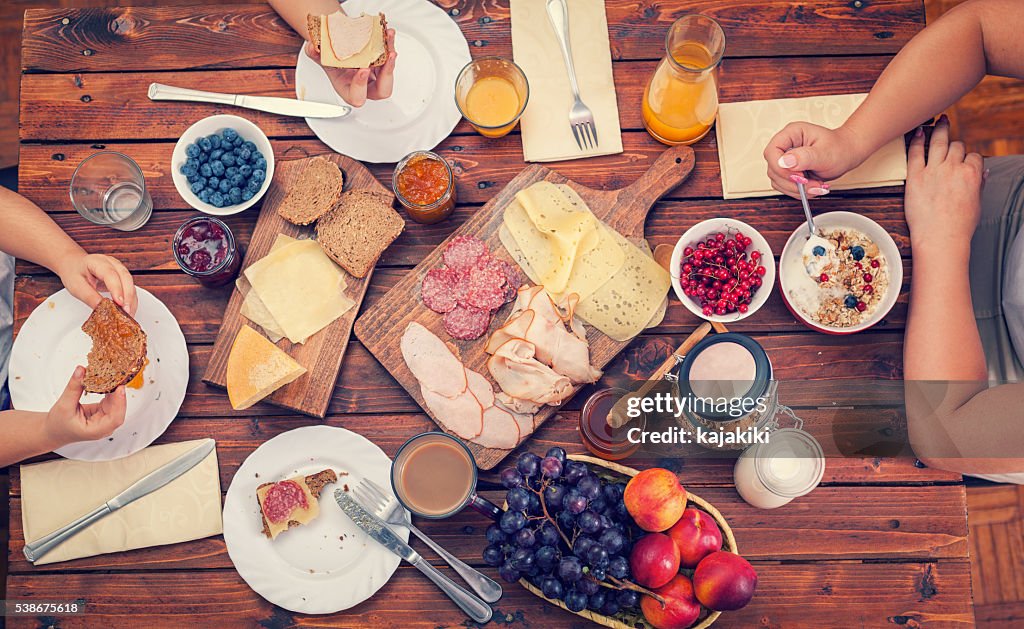 Young Happy Family Having Breakfast