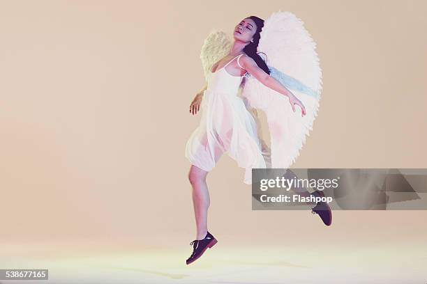 portrait of woman wearing angel wings - angel white dress stock pictures, royalty-free photos & images