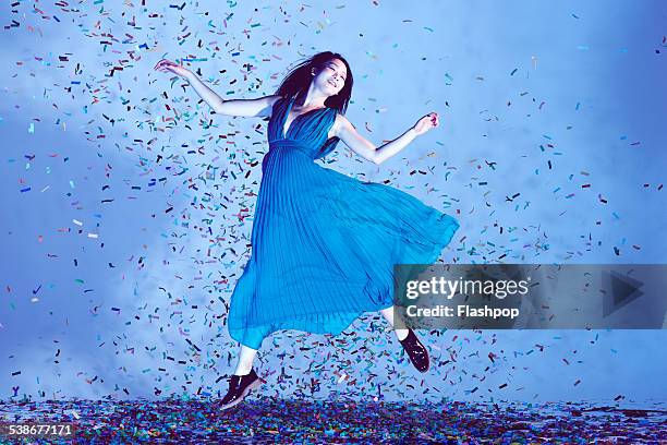 portrait of woman jumping in confetti - sleeveless imagens e fotografias de stock