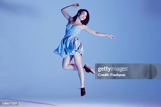 portrait of woman jumping - mini dress stock pictures, royalty-free photos & images