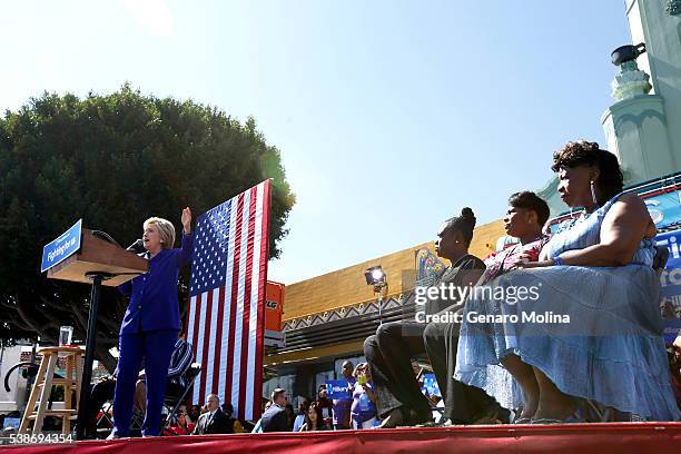 Democratic presidential candidate Hillary Clinton gives a speech as Wanda Jackson, from right, mother of Oscar Grant, Gwen Carr, mother of Eric...