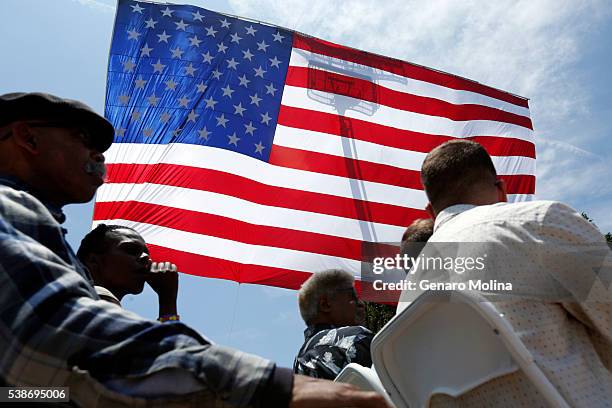 Huge U.S. Flag frames supporters of Democratic presidential candidate Hillary Clinton before her arrival at the Get Out The Vote rally in Leimert...