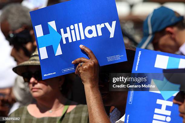 Supporter uses a sign to block the sun before Democratic presidential candidate Hillary Clinton attends a Get Out The Vote rally in Leimert Park...