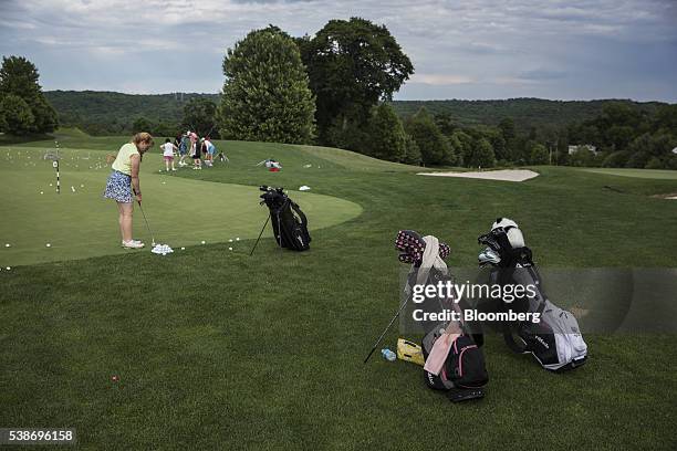 Golfers practice on the green before Donald Trump, presumptive Republican presidential nominee, not pictured, speaks during a primary night event at...