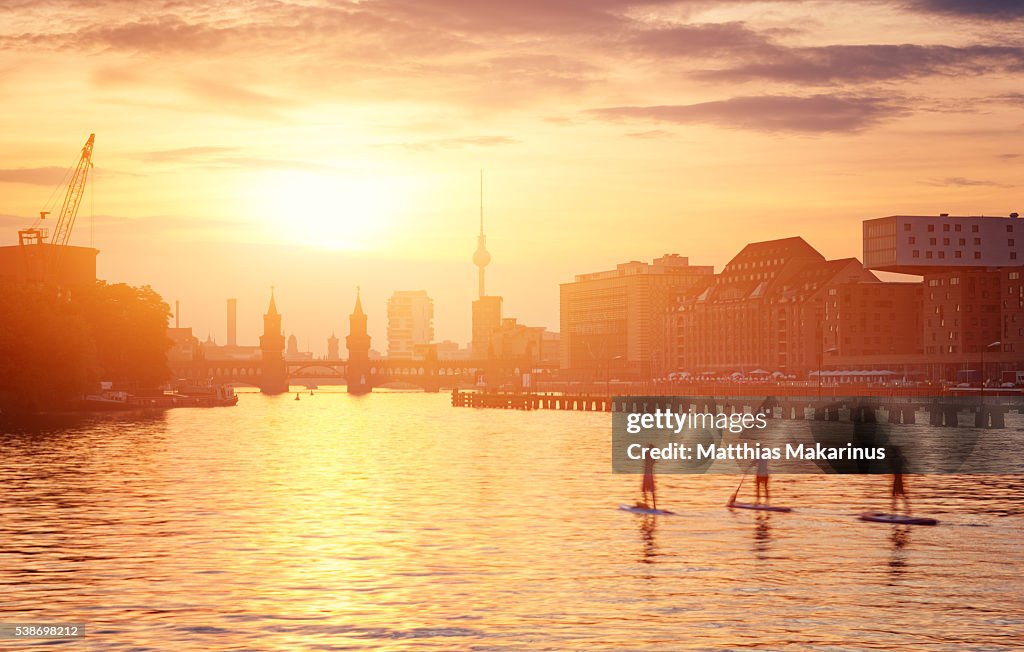 Berlin Summer Sunset Skyline with Paddle Surfing People