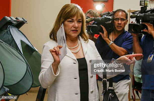 Senate candidate Loretta Sanchez looks for a ballot box after casting her vote at Orange High School with her husband Jack Einwechter on the morning...