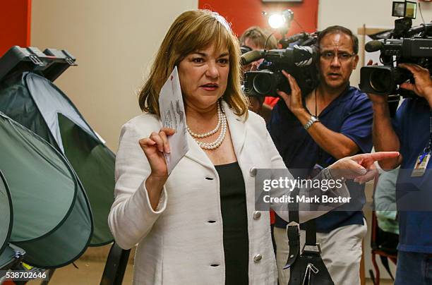 Senate candidate Loretta Sanchez looks for a ballot box after casting her vote at Orange High School with her husband Jack Einwechter on the morning...