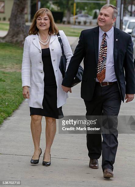 Senate candidate Loretta Sanchez walks to the polling place to cast her vote at Orange High School with her husband Jack Einwechter on the morning of...