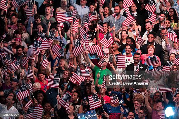 Supporters cheer as they wait for the start of a primary night rally for Democratic presidential candidate Hillary Clinton at the Duggal Greenhouse...