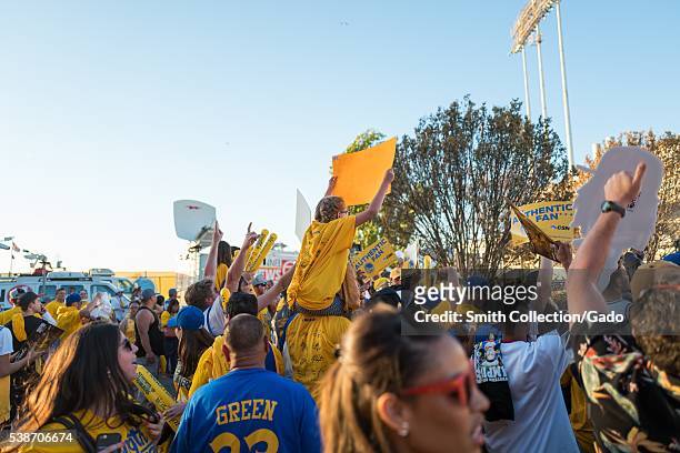 Following Game 2 of the National Basketball Association Finals between the Golden State Warriors and the Cleveland Cavaliers, Warriors fans hold up...