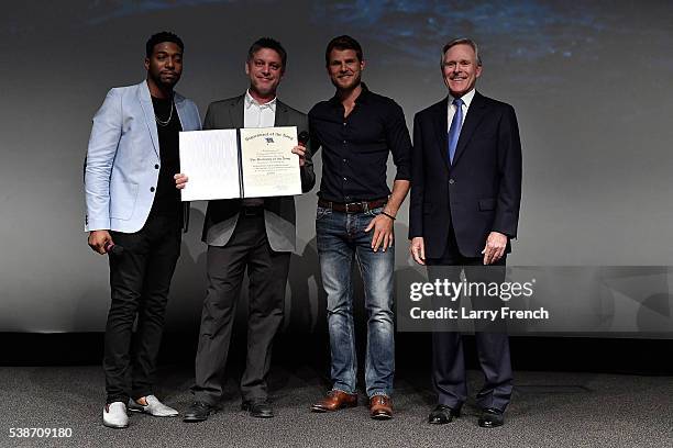 Jocko Sims, Executive Producer Steven Kane and Travis Van Winkle are presented with the Distinguised Public Service Award by Secretary of the Navy...